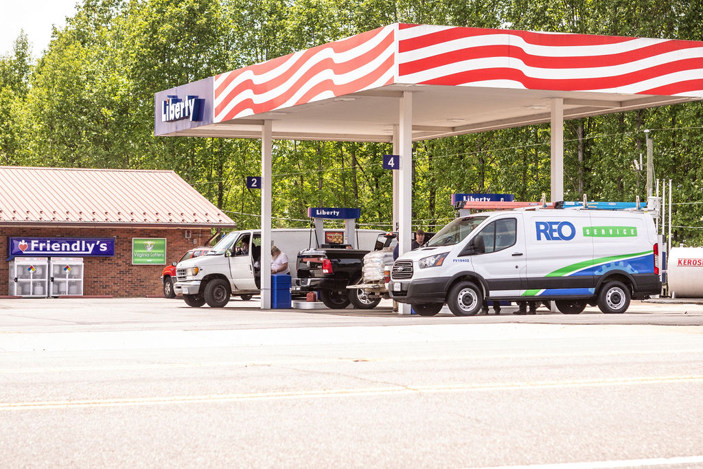 Hutchens(229) Liberty gasoline station with REO Service van parked at pump