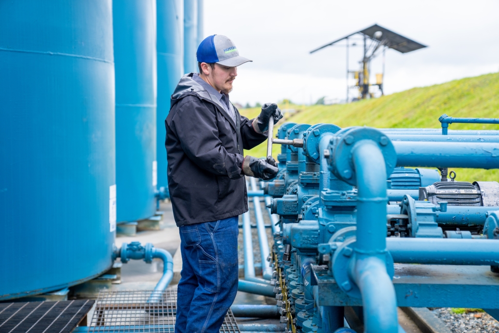 Technician tightening fuel pipes.