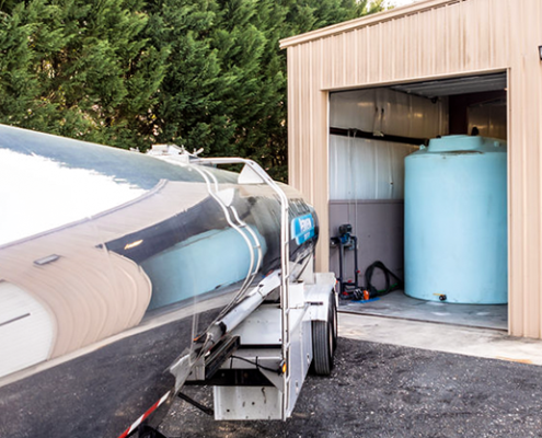 Hutchens tanker backing in to fill DEF storage tank in garage