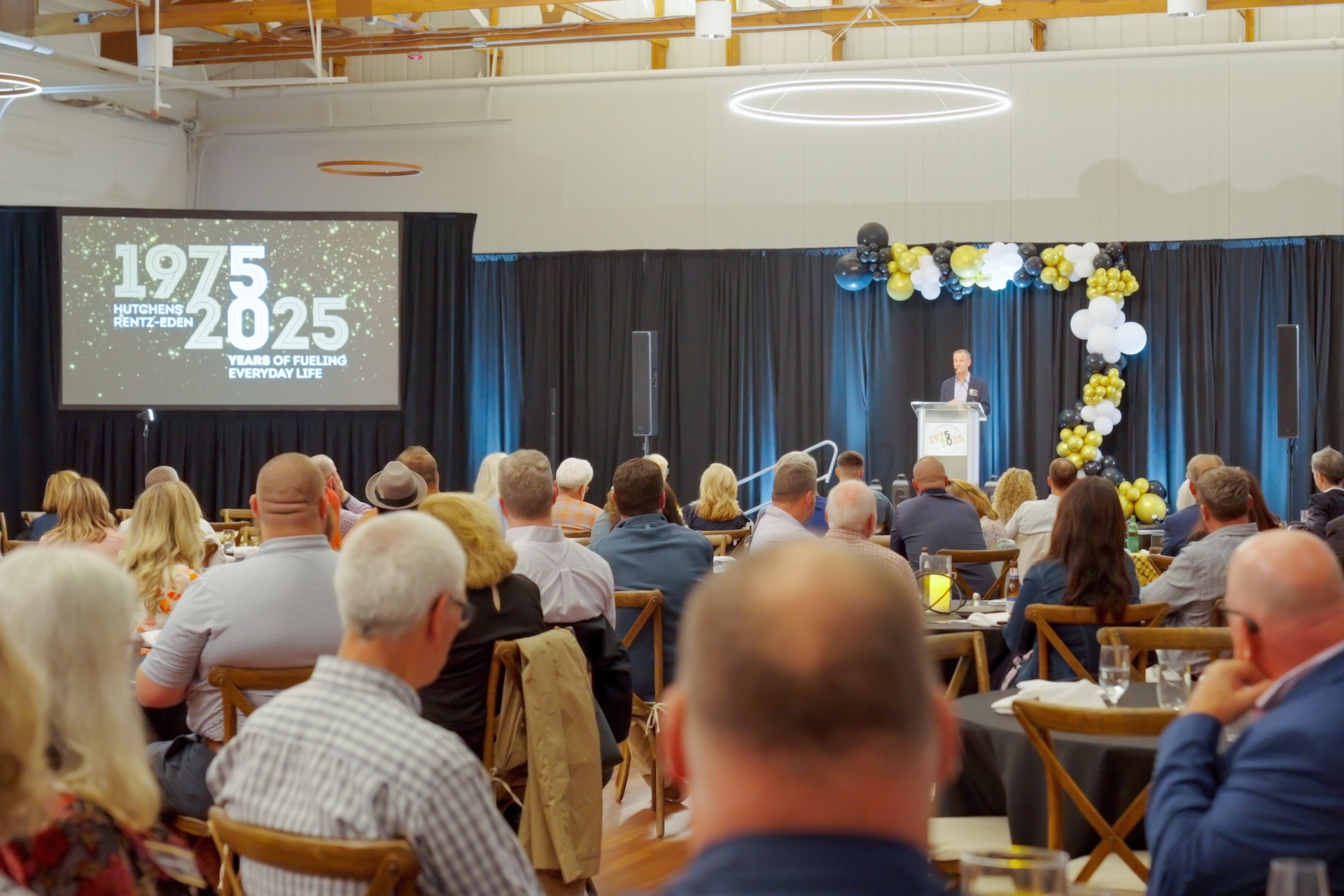 Listening to a speech at Hutchens 50th Anniversary Event