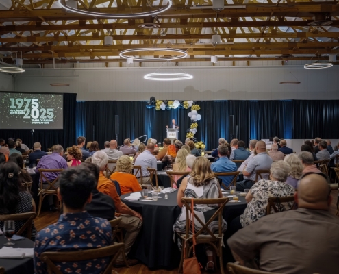 Listening to a speech at Hutchens 50th Anniversary Event
