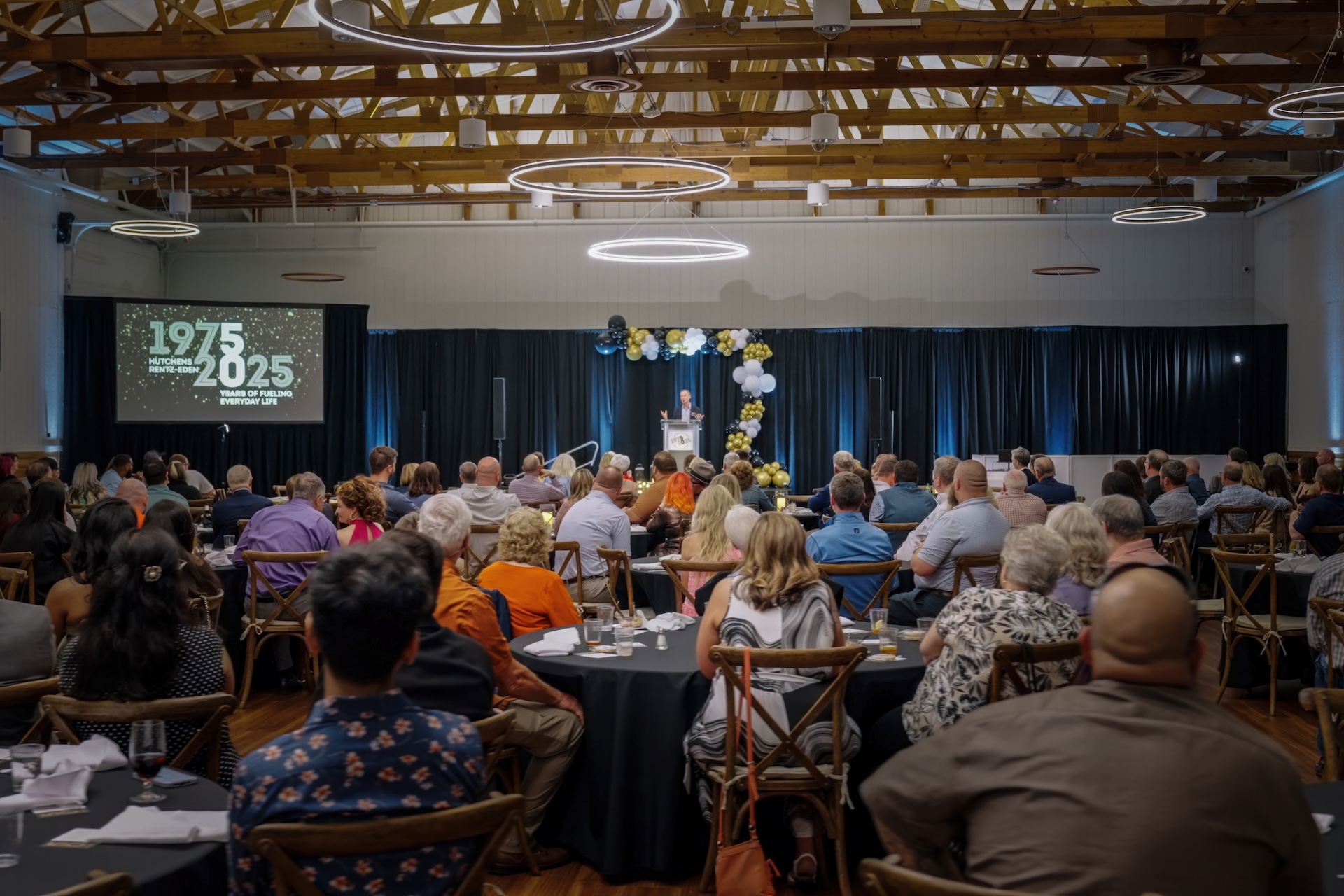 Listening to a speech at Hutchens 50th Anniversary Event