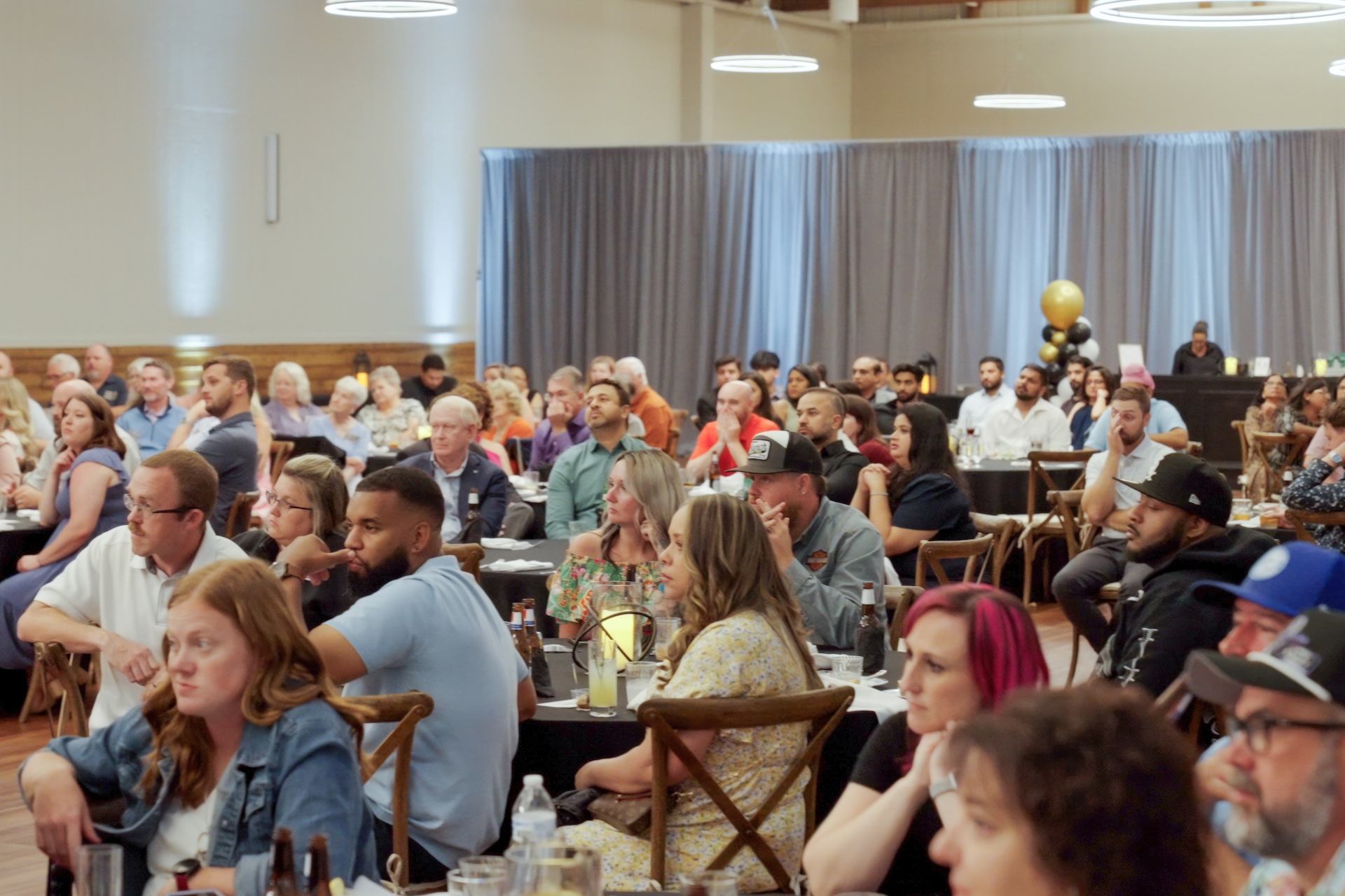 Listening to a speech at Hutchens 50th Anniversary Event