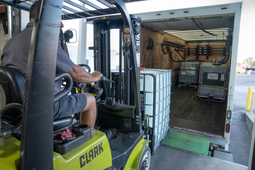 HRE_Verona-13 DEF Storage Totes being loaded onto a box truck by an HRE forklift operator.