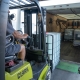 DEF Storage Totes being loaded onto a box truck by an HRE forklift operator.