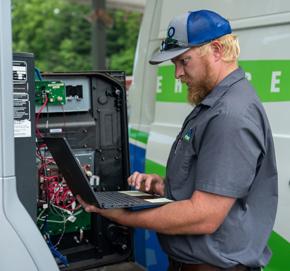 HRE-134 Hutchens REO technician working on a fuel pump